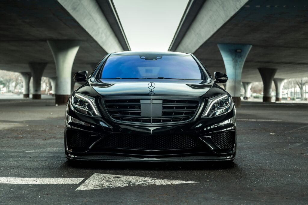 pexels-photo-3541743-3541743 Sleek black luxury car parked outdoors under a modern urban bridge in Sacramento.